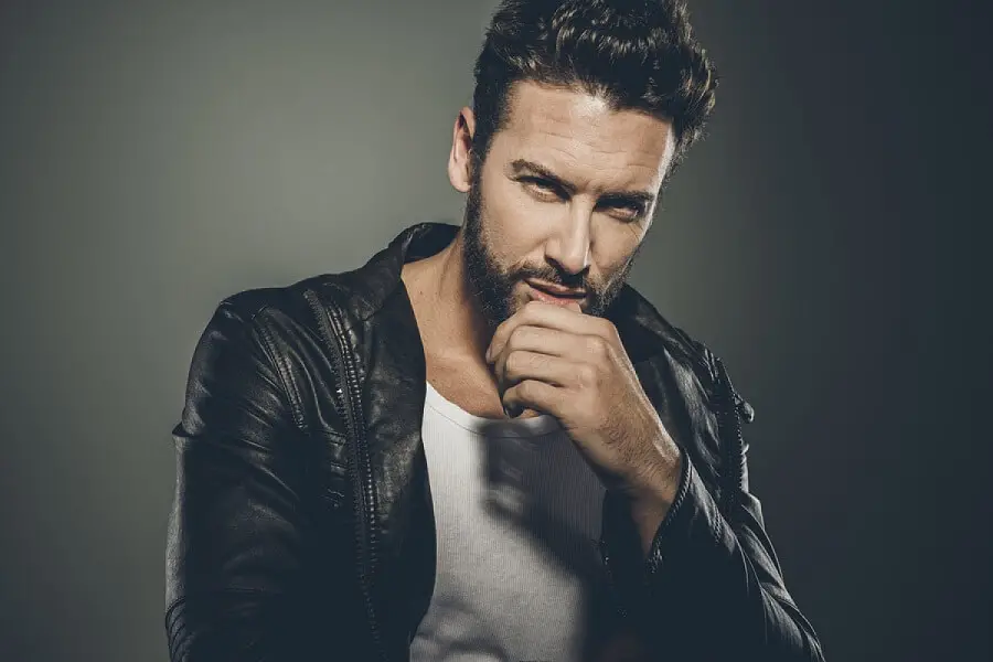 man looking at the camera, posing as tough